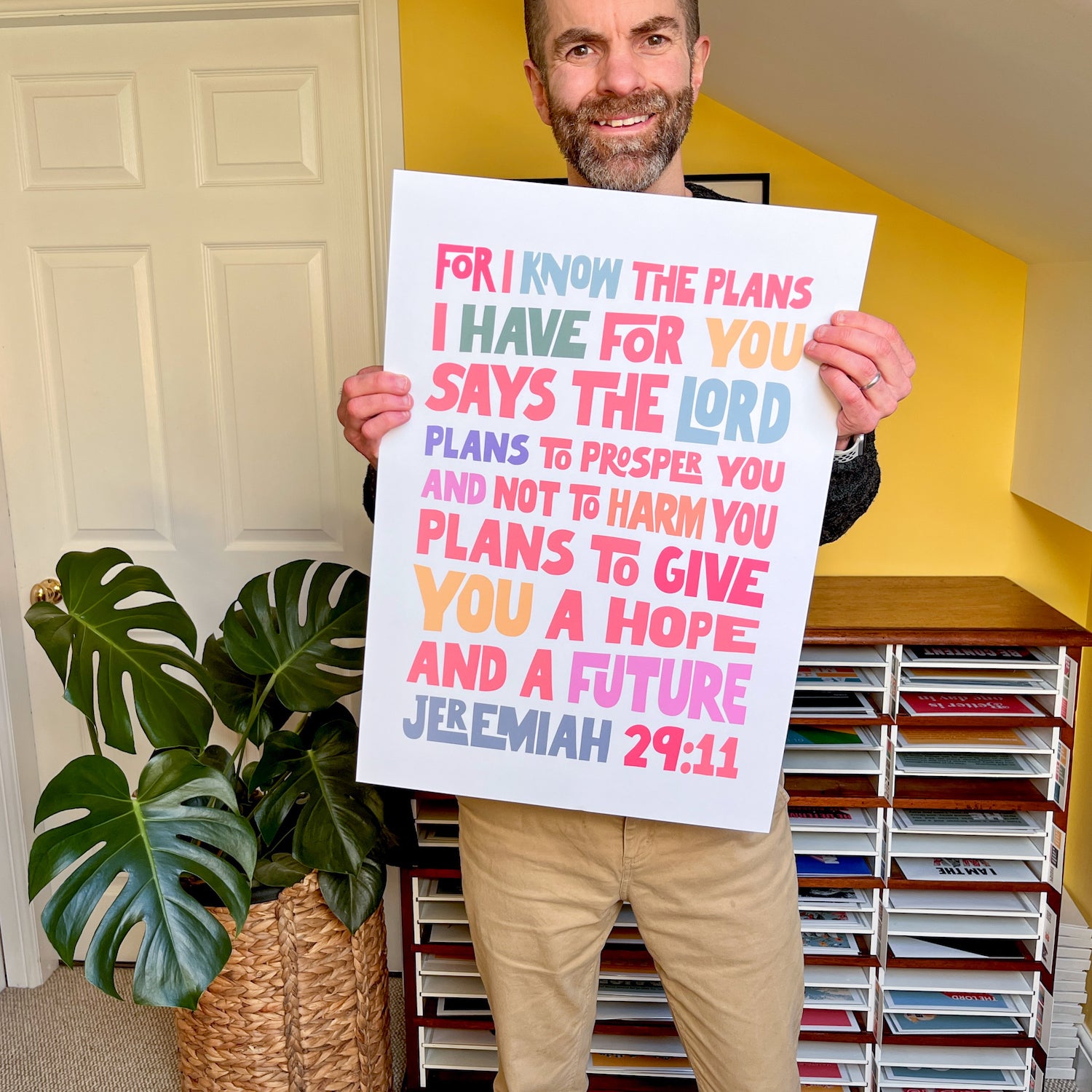 Nick, owner of The Christian Poster Company, holding an A2 print of his Jeremiah 29 design
