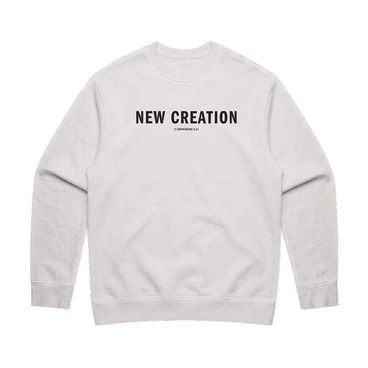 Faded bone color sweatshirt featuring the text 'NEW CREATION' in bold black letters on the front.
