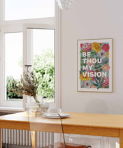 Colorful floral wall art featuring the text 'BE THOU MY VISION' in bold letters, framed and displayed in a bright room.