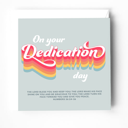 A modern Christian rainbow coloured dedication card with a bible verse on the cover. 