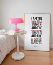 Christian poster featuring the text 'I AM THE WAY AND THE TRUTH AND THE LIFE' with floral accents, framed and displayed on a