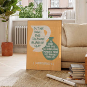 Poster featuring the text 'But we have this treasure in jars of clay' with a modern design, displayed in a cozy room.