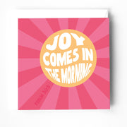 Greeting card with pink rays background, featuring the text 'JOY COMES IN THE MORNING' and 'PSALM 30:5'.