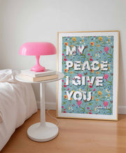 Poster featuring the text 'MY PEACE I GIVE YOU' with floral background and John 14:27, displayed beside a pink lamp.