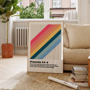 Wall art poster featuring Proverbs 3:5-6 with colorful stripes, displayed in a cozy living room setting.