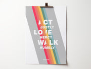 Poster featuring the text 'ACT JUSTLY, LOVE MERCY, WALK HUMBLE' in bold white letters on a colorful striped background.