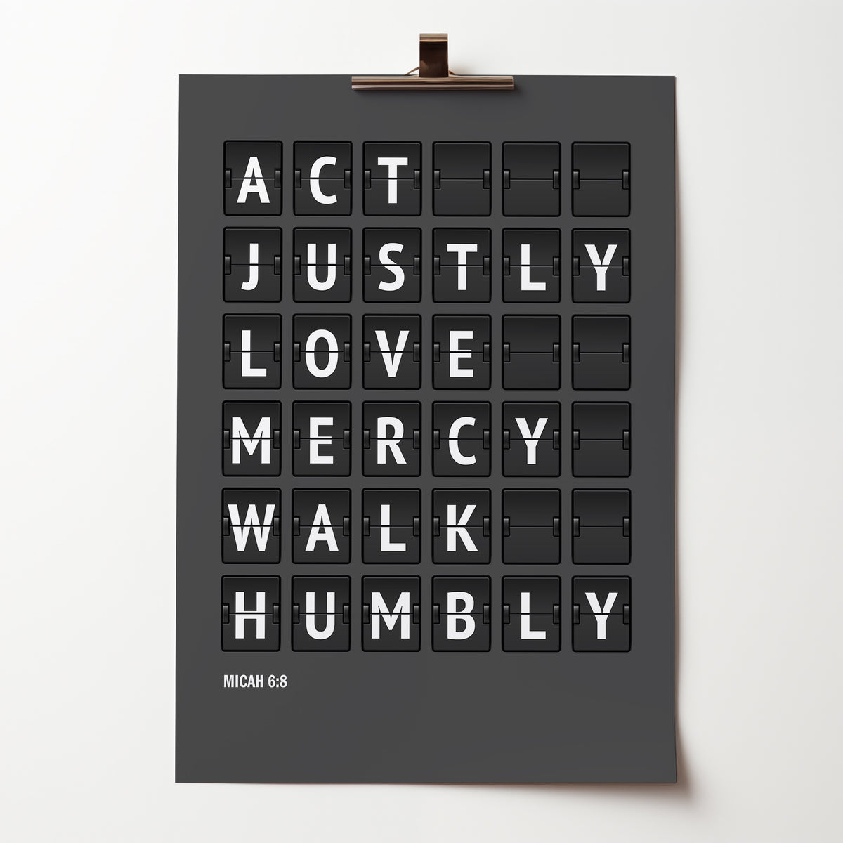 Act justly, love mercy, walk humbly — Micah 6:8 poster in white flip-board lettering on charcoal grey, held by a bulldog clip.
