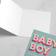 Greeting card featuring bold text 'BABY BOY' in blue and pink, with a blank interior for messages.