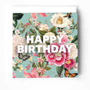 Birthday greeting card featuring floral design with the text 'HAPPY BIRTHDAY' in bold white letters.