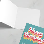 Birthday greeting card with colorful text 'Happy Birthday' and a bible verse on the cover, blank inside.