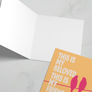 Greeting card with orange cover featuring the text 'This is my beloved, this is my friend' in pink and blue.