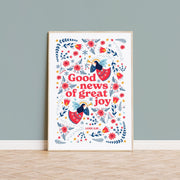 Poster featuring the text 'Good news of great joy' surrounded by colorful flowers and angels, scripture reference Luke 2:10