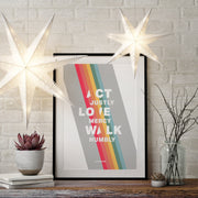 Poster featuring the text 'ACT JUSTLY, LOVE MERCY, WALK HUMBLE' with colorful stripes, displayed with decorative stars and a