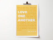 Yellow poster featuring the text 'Love one another' and a Bible verse from John 13:31-35, clipped to a wall.