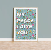 Floral poster with the text 'MY PEACE I GIVE YOU' and John 14:27, framed and displayed against a light blue wall.