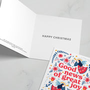 Pack of Christmas cards featuring colorful designs and a bible verse, inside reads 'Happy Christmas'.
