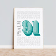 Typographic poster featuring Psalm 91 in green and white, framed, displayed against a light wall.