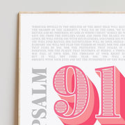 Modern typographic poster featuring Psalm 91 with bold text and decorative elements, framed in light wood.