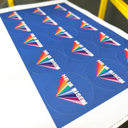 Sticker sheets featuring the text 'He is risen' in bold white letters on a colorful rainbow background.