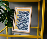 Framed poster with the text 'We have this hope as an anchor for the soul' over a wave pattern, displayed on a yellow shelf.