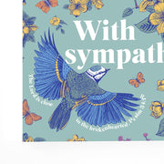Colorful card featuring a blue bird and flowers, with the text 'With Sympathy' and a bible verse.