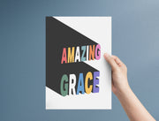 Poster featuring the text 'AMAZING GRACE' in colorful letters, held against a blue background.