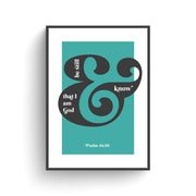 Poster featuring the text 'Be Still and Know that I am God' in black and white on a teal background, framed.