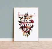 Poster featuring the text 'Immanuel, God with us' surrounded by colorful floral designs, framed and displayed on a wall.